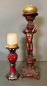 Two wooden red painted ornamental candle holders