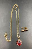 A yellow gold (18ct marked 750) jewellery set comprising necklace with heart shaped red stone