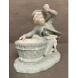 A late Victorian Mintons porcelain figure of a boy with a basket, marked to base