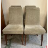A set of four grey upholstered dining chairs