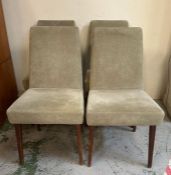 A set of four grey upholstered dining chairs