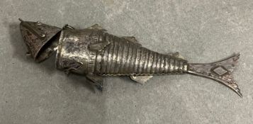An articulated white metal fish