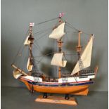 A wooden scale model of The Golden Hind on plinth