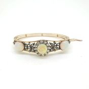 15ct Victorian Opal and diamond bangle. A central cabochon opal cluster with a diamond flower design
