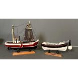 Two wooden painted boats, a Life Boat and a Fishing Trawler