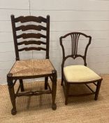 An oak rush seated hall chair on bun feet with turned stretchers and a mahogany cream upholstered