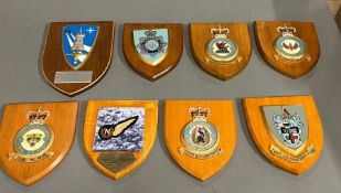 Eight wall hanging shield plaques, police and army