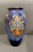A Lambeth Doulton vase with floral decoration, approximately 30 cm high.