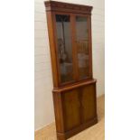 A yew double corner cabinet with glazed door above and cupboard under (H189cm W84cm)