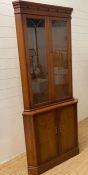 A yew double corner cabinet with glazed door above and cupboard under (H189cm W84cm)