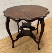 A shaped circular top side table on tapering legs joined by an under tier (H68cm Dia73cm)
