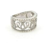 A wide band ring with open work entwined loops set with diamonds .Marked 18K
