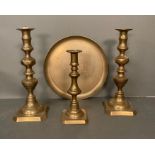 A selection of brass items to include candle sticks and a plate