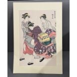 A Japanese wood block print of three ladies.