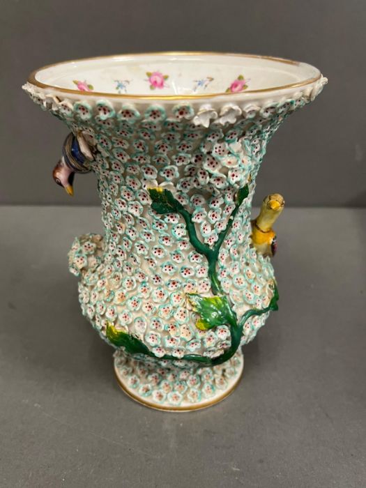 A 19th century vase in the manner of Meissen with bird decoartion.