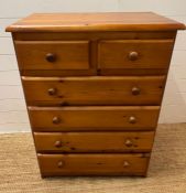A two over four pine chest of drawers (H102cm W77cm D45cm)
