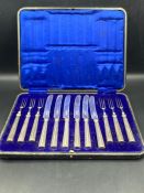 A boxed set of six silver handled fruit knives and forks by William Hutton & Sons Ltd, hallmarked