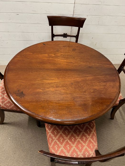 A William IV style mahogany dining table, circular top over a octagonal column and raised on a tri- - Image 4 of 5