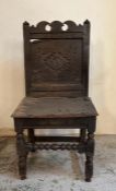 An oak carved hall chair with central carved back panel AF