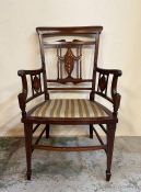 An Edwardian mahogany arm chair wit decorative inlaid splats to back and arms on square tapering