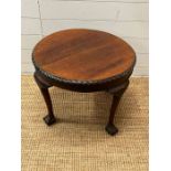 A circular side table on ball and claw feet (H46cm Dia60cm)