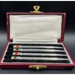 A cased set of 4 Art Deco silver and enamel bridge pencil markers, c.1930, engine turned in fitted