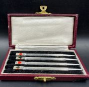 A cased set of 4 Art Deco silver and enamel bridge pencil markers, c.1930, engine turned in fitted