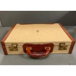 A vintage cream and tanned leather brief case