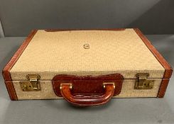 A vintage cream and tanned leather brief case