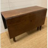 A mahogany drop leaf table on castors