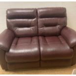 A burgundy leather two seater sofa by Lazyboy