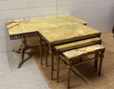 An onyx topped brass frame coffee table on down swept legs with empire column stretcher and a nest