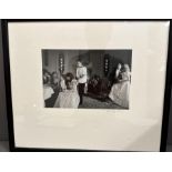 A framed photograph by Dudley Reed of a 1980's dinner party signed