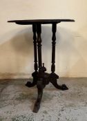 A mahogany occasional table with walnut top on splayed legs with central finial AF (H68cm Dia53cm)