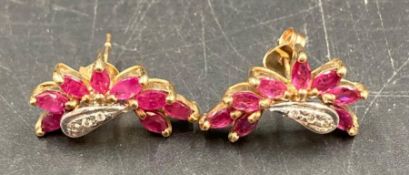 A pair of 9ct gold earrings with ruby style stones.