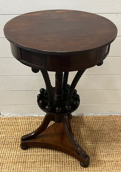A mahogany side table with twisted centre spindles terminating on a circular platform surround by