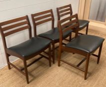 A mid century dining table with folding leaf and four Mid Century black upholstered chairs