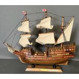 A wooden scale model of The Golden Hind on plinth