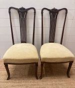 A pair of cream upholstered mahogany side chairs