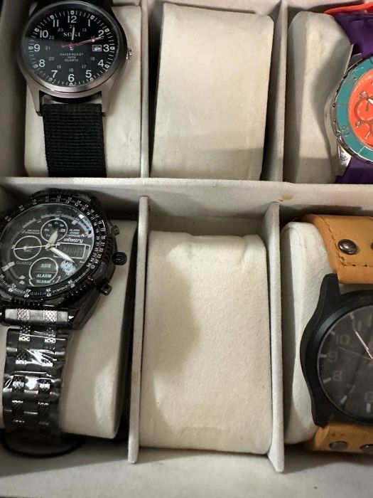 A selection of wristwatches in display case to include: Bulova, Geneva, Skmei, Infantry, 18 in - Image 3 of 6