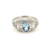 A platinum Art Deco style Aquamarine and diamond ring with baguette and round brilliant diamonds.