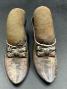 A pair of Victorian, white metal, pin cushions in the form of shoes.