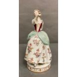 In the manner of Meissen a figure of a lady dancing with floral dress with flower decoration H26cm