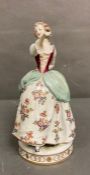In the manner of Meissen a figure of a lady dancing with floral dress with flower decoration H26cm