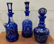Three cobalt blue cut glass decanters