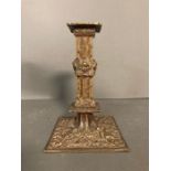A Victorian style brass candle holder with cherubs to base and stem
