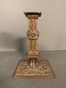 A Victorian style brass candle holder with cherubs to base and stem