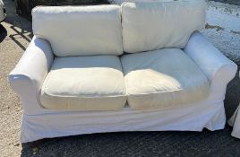 A pair of two seater sofa with loose covers by Oka