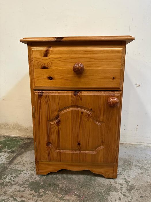 A pine single drawer, single cupboard bedside cabinet