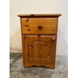 A pine single drawer, single cupboard bedside cabinet
